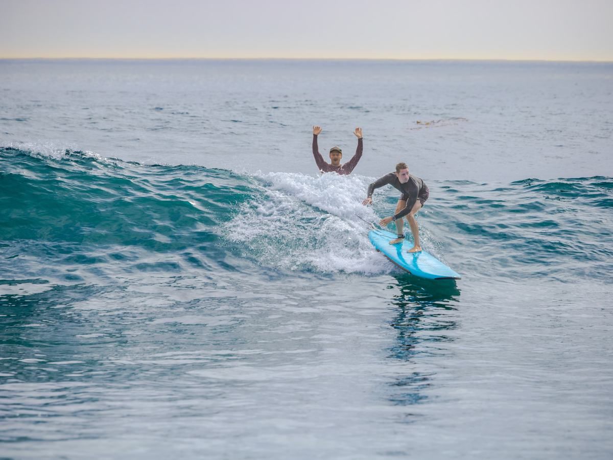 A surfer riding a wave in Laguna Beach